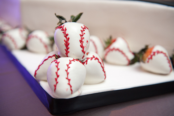 clever dessert decor - strawberries covered in white chocolate and decorated in red icing to look like baseballs - photo by Houston based wedding photographer Adam Nyholt